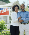 Couple in front of a sold house
