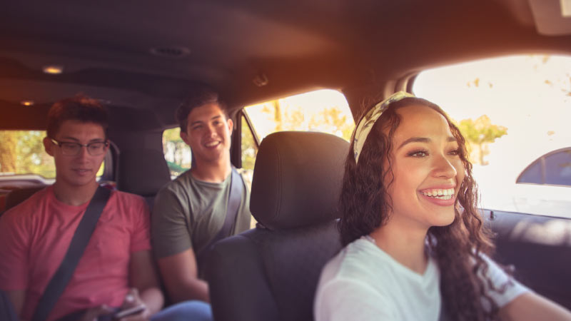 three people in car