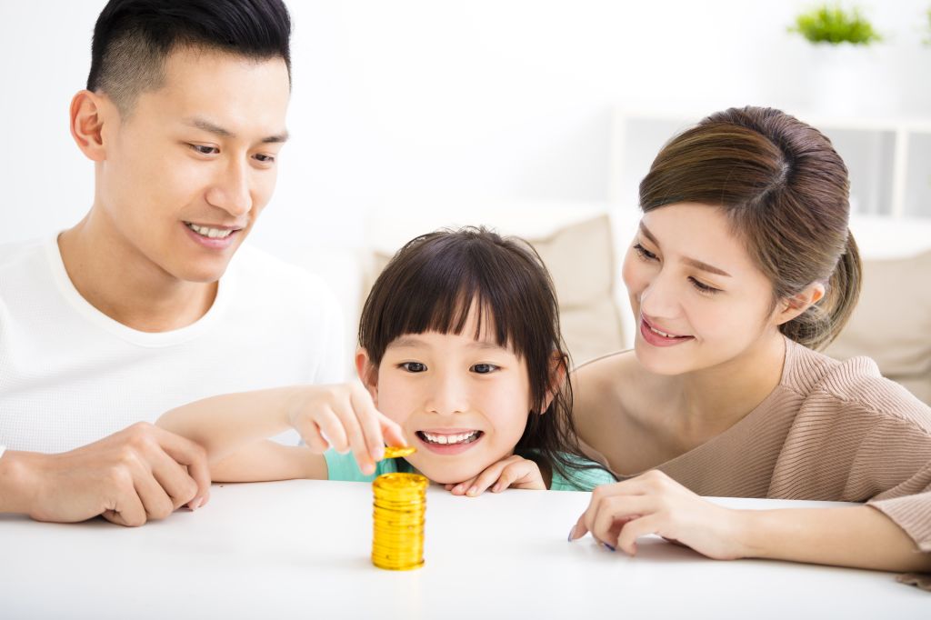 Asian parents teaching child about financial literacy