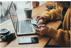 Person entering their credit card details on a laptop