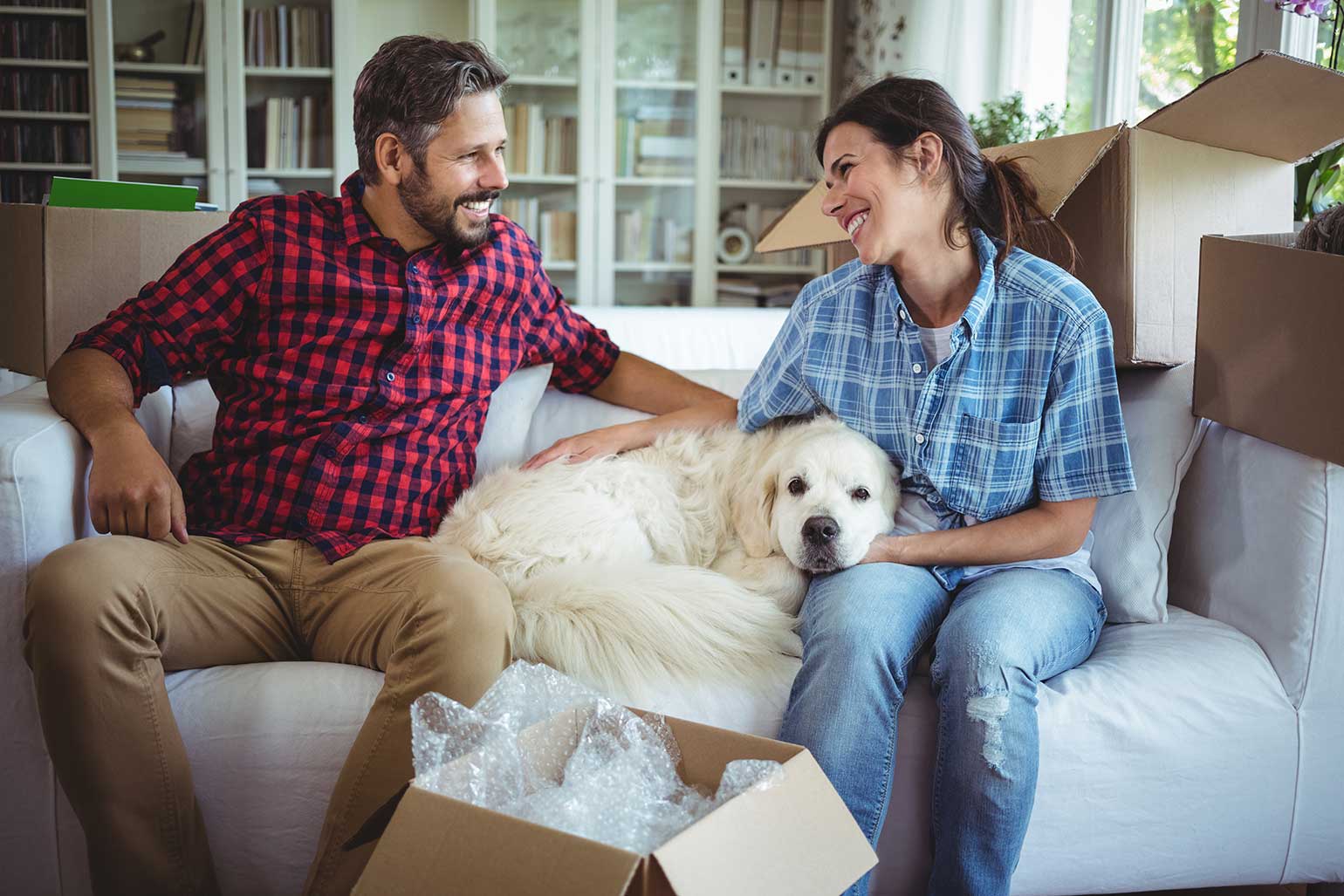 First time homebuyers happily unboxing pet's stuff