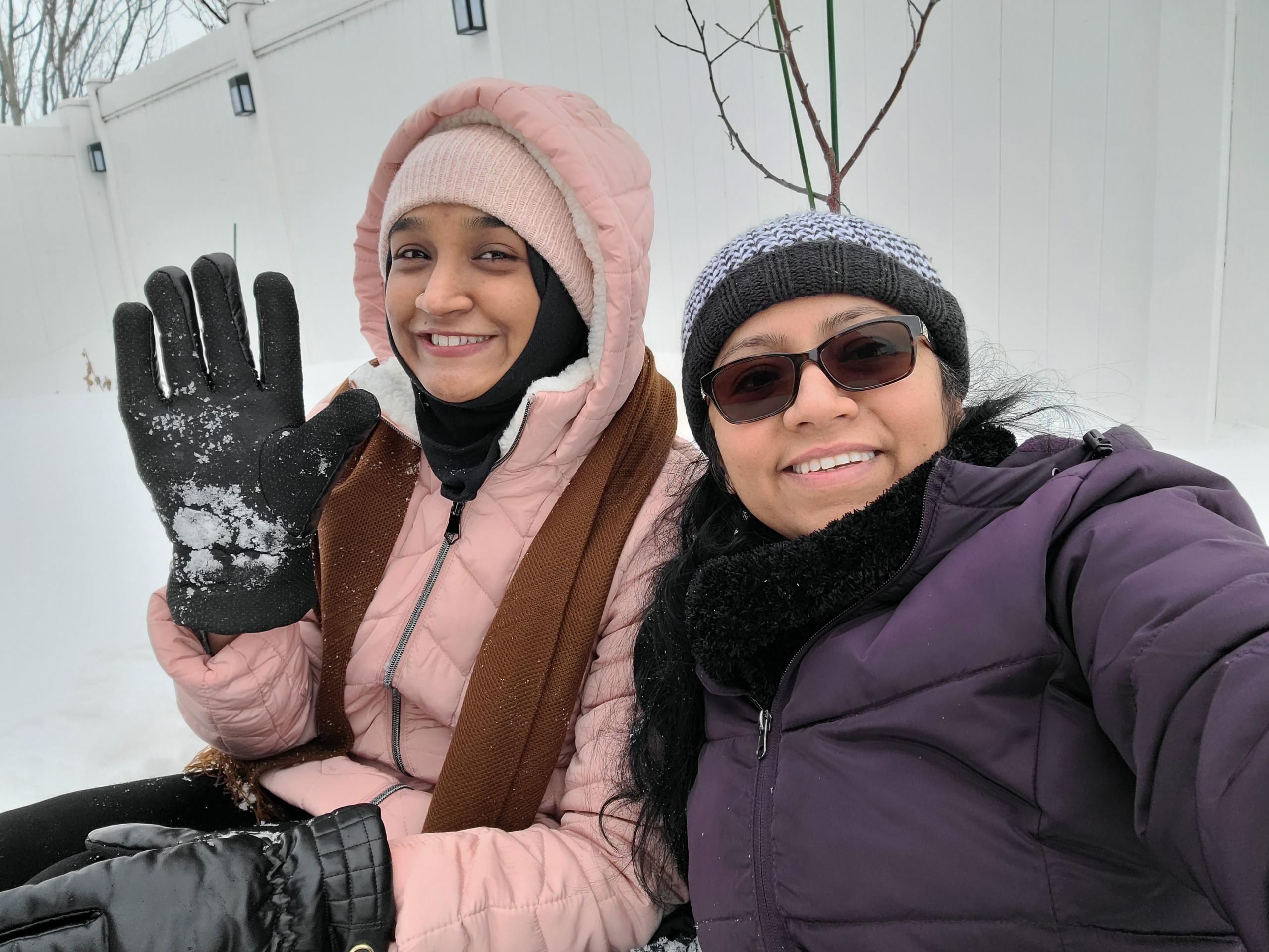 Iqraa Sayed and her Auntie in the snow wearing heavy coats