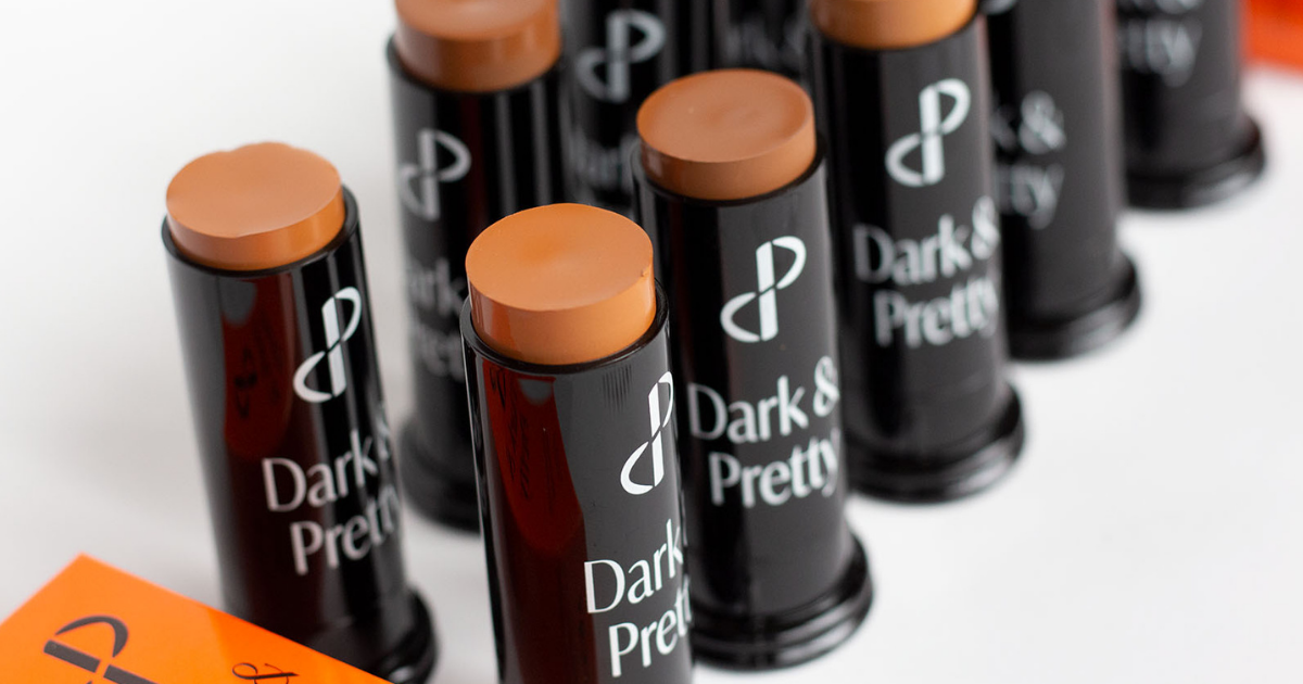 A photo of make-up products that say Dark and Pretty on each one. 