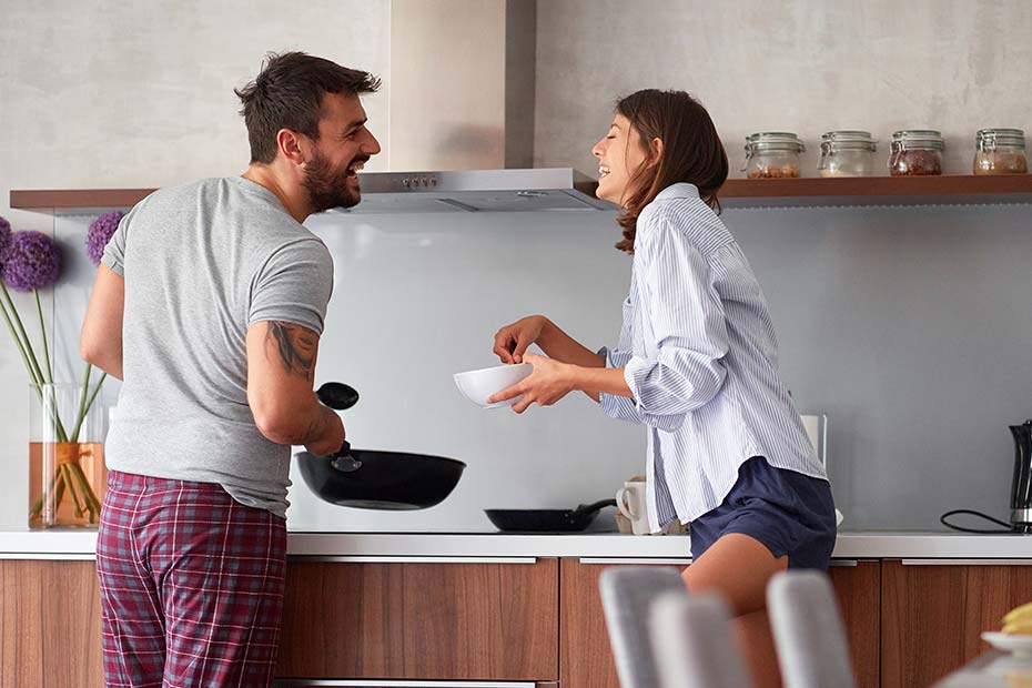 Young couple having fun while cooking.