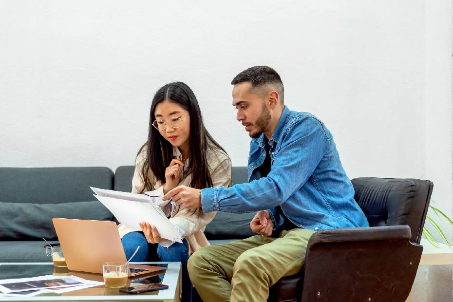 Two people sitting on couch looking at screen