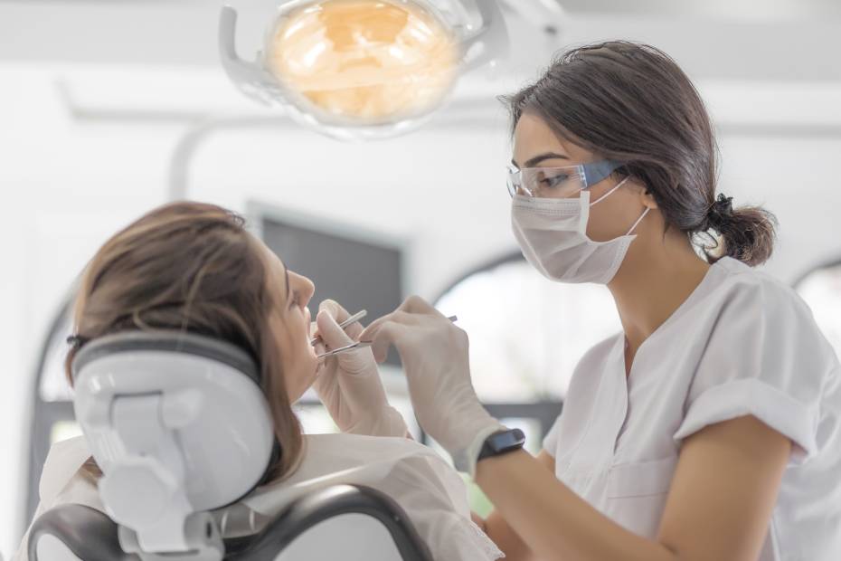 A female Dentist examining her patient in dental clinic