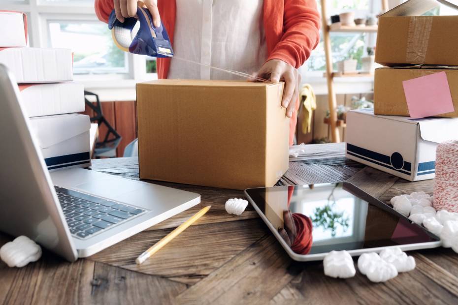 Person packing a cardboard box