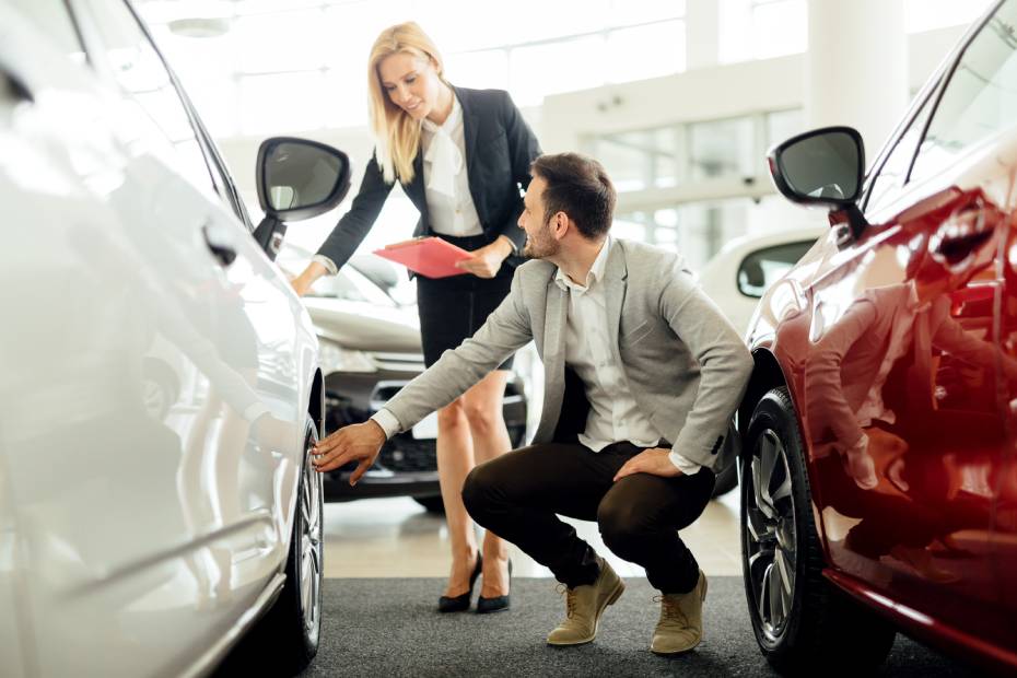 Person checking out car at a dealership