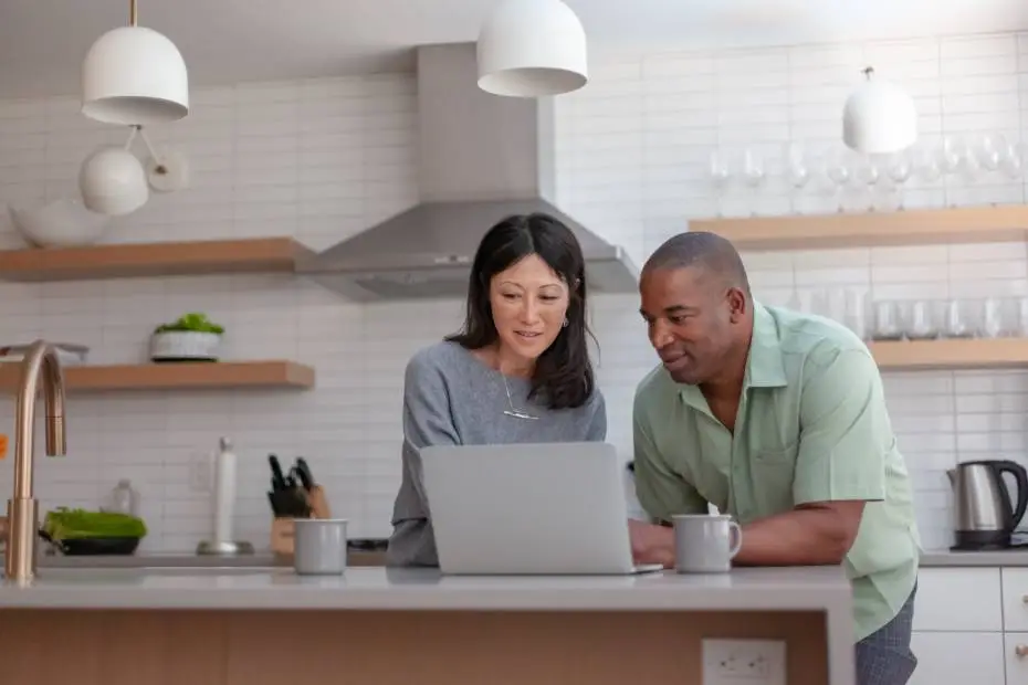A couple in their 40s reviewing mortgage options in the kitchen