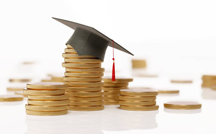 Graduate cap on stacks of coins