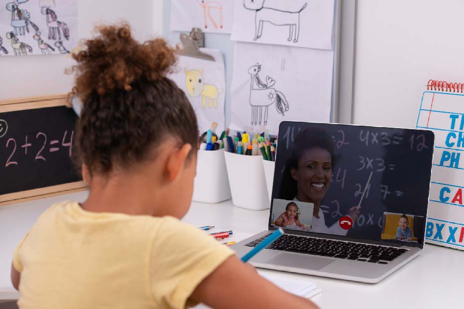 Young girl at her desk during a Zoom call for school