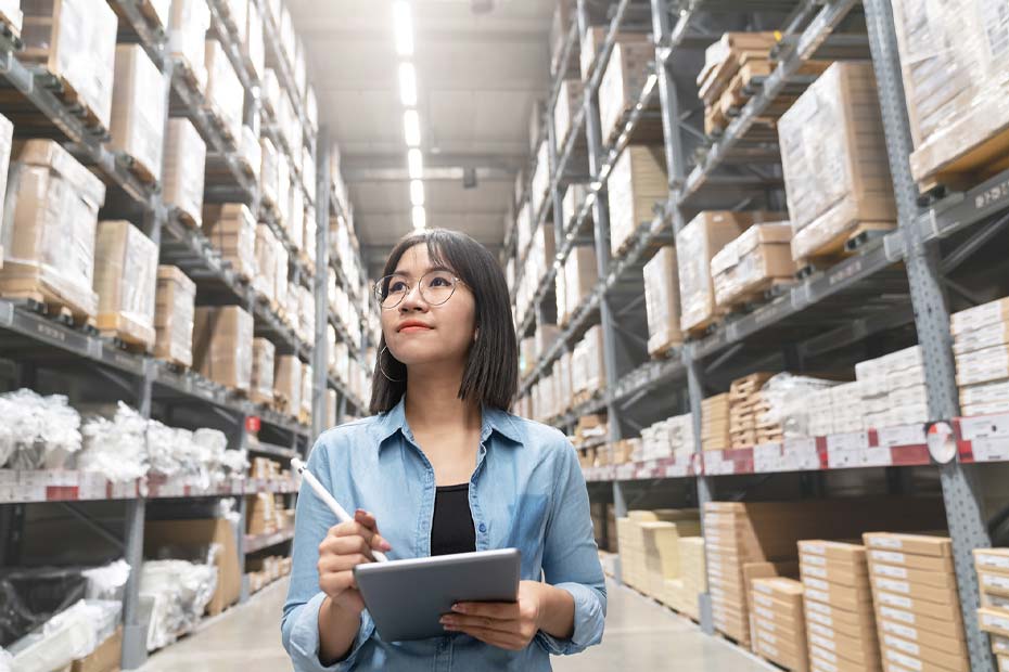 Lady checking inventory list in warehouse