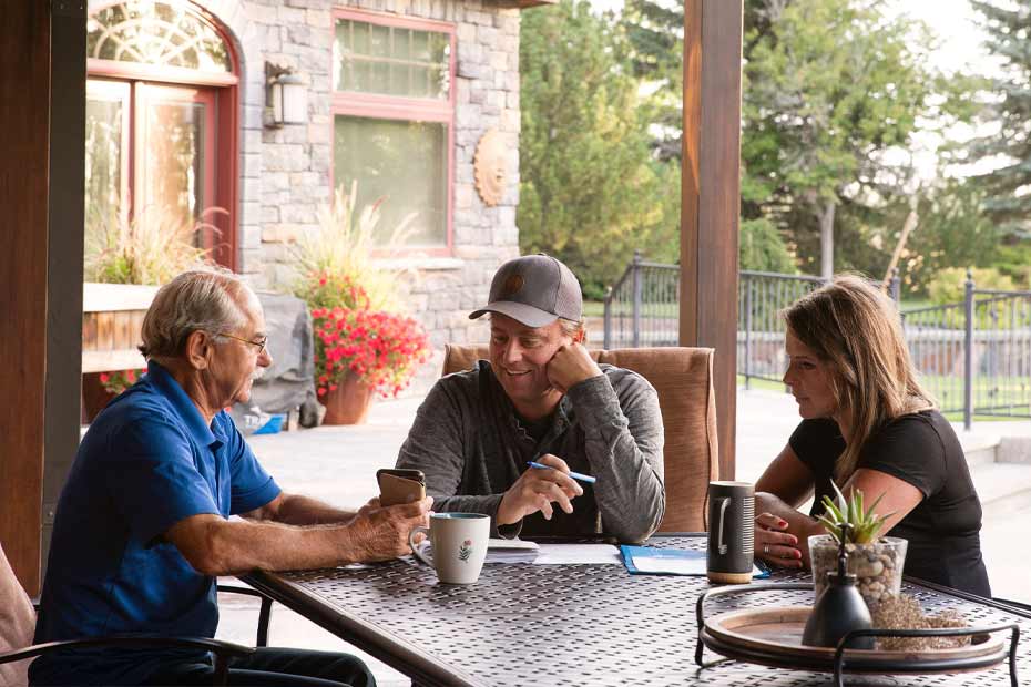 3 farmers sit around the table discussing opportunities