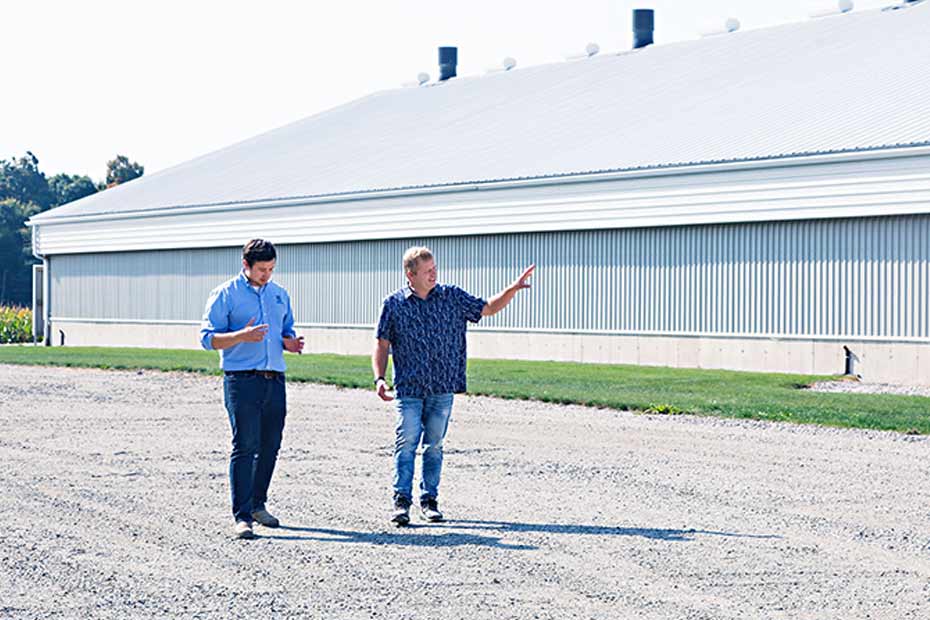 Farmers are standing in a field discussing opportunities