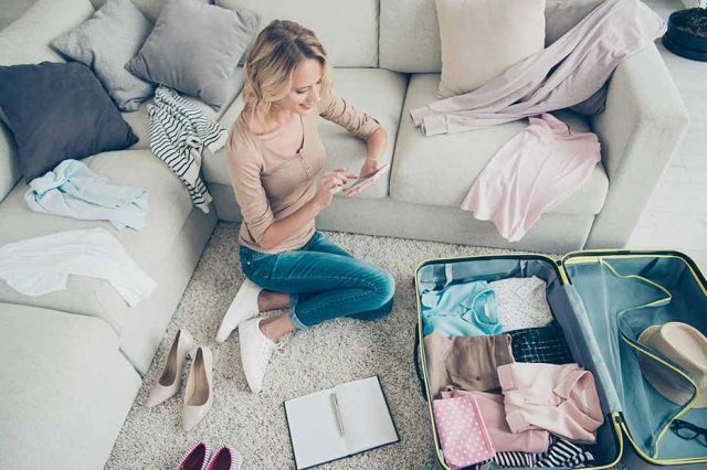 A young Canadian woman packing to travel to the US