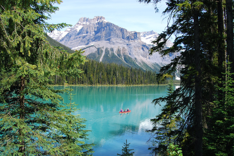 Nature, mountains and an orange canoe in the middle.