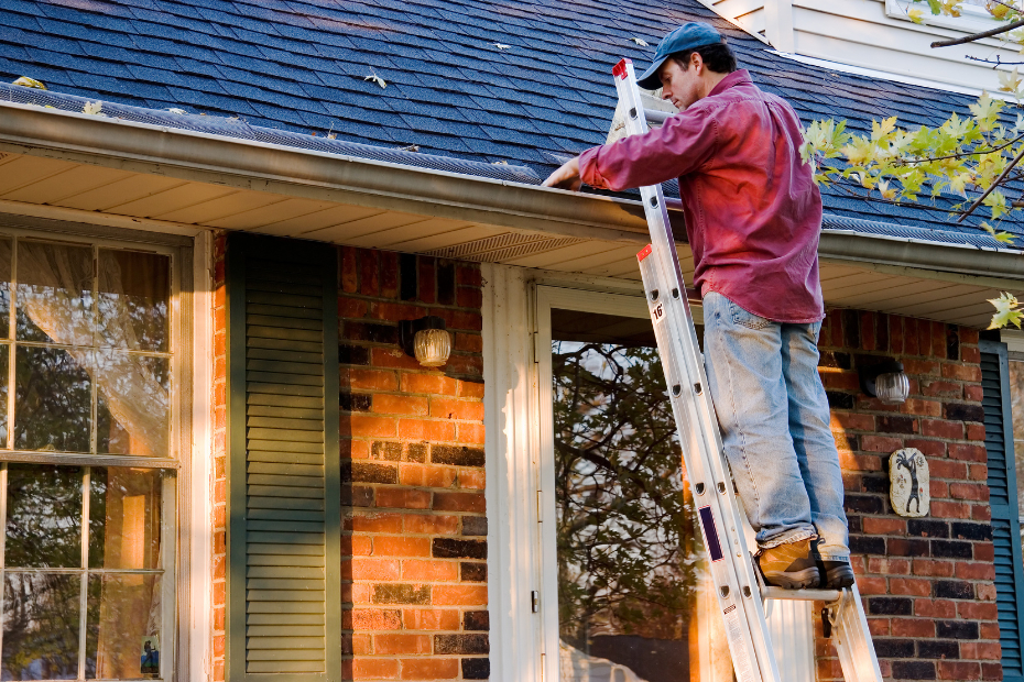 Man fixing a house on a ladder