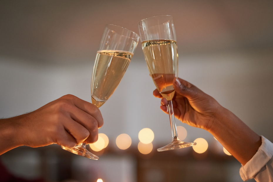 A couple's hands, toasting with champagne