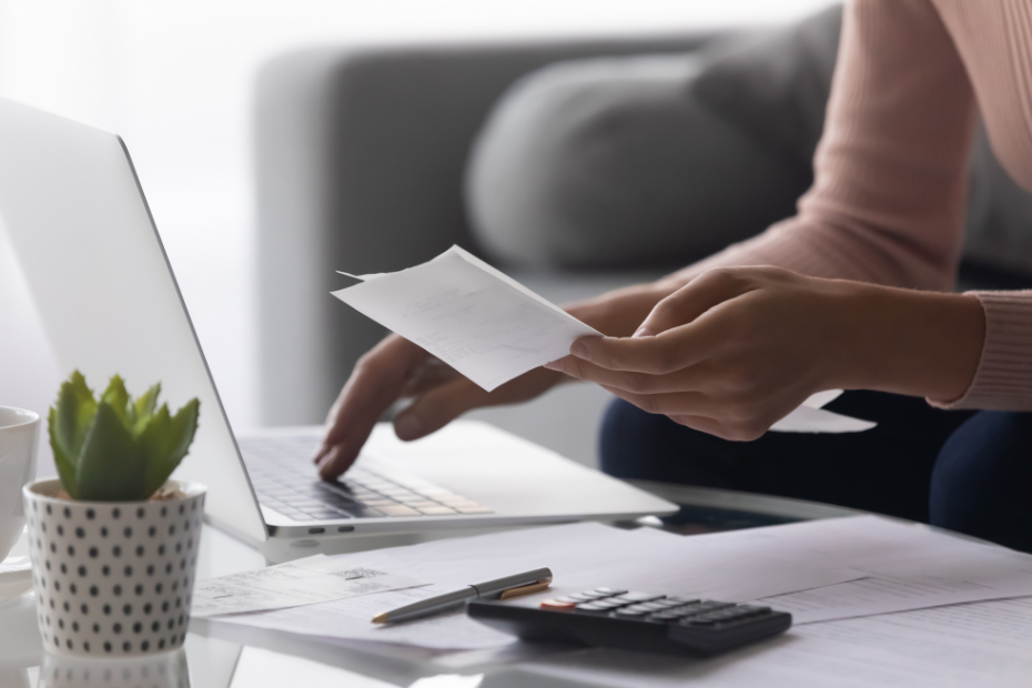 Out of focus woman paying bills on her computer