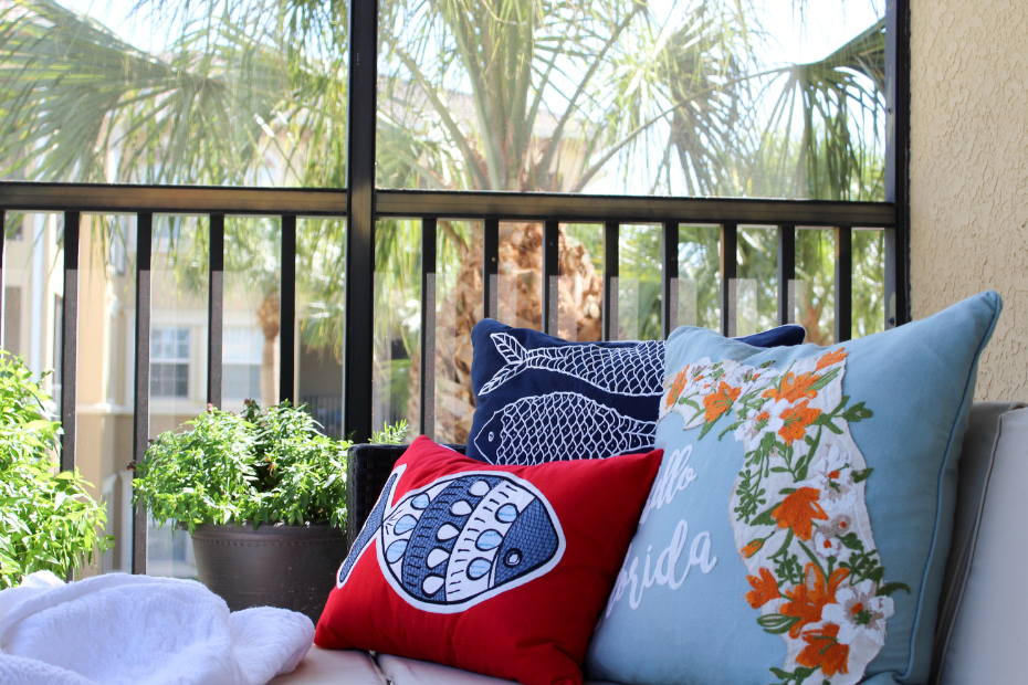 Serene image of an outdoor sofa on a porch with comfy pillows