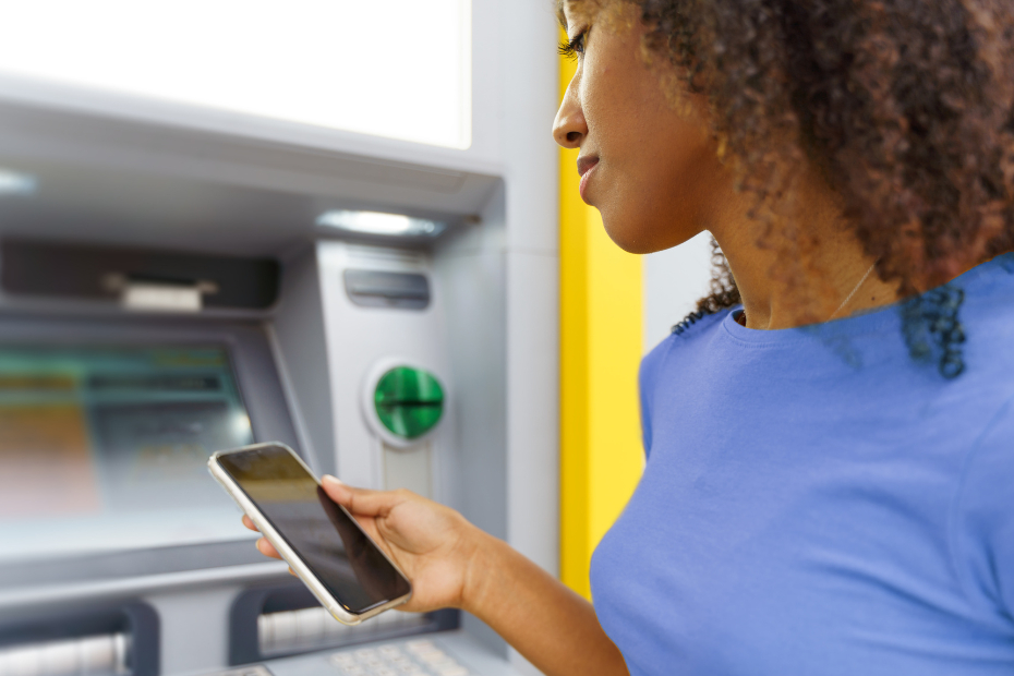 Young black woman banking at an ATM