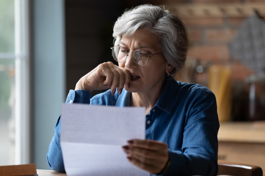 A middle-aged woman looking at a financial statement