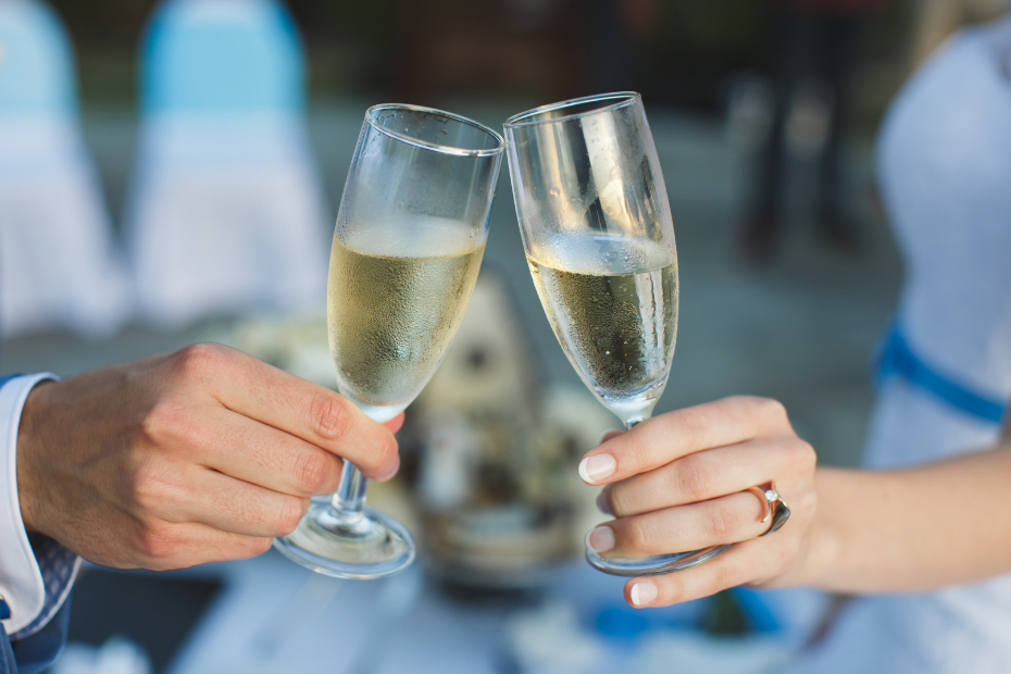 Close up of a couple clinking champagne glasses