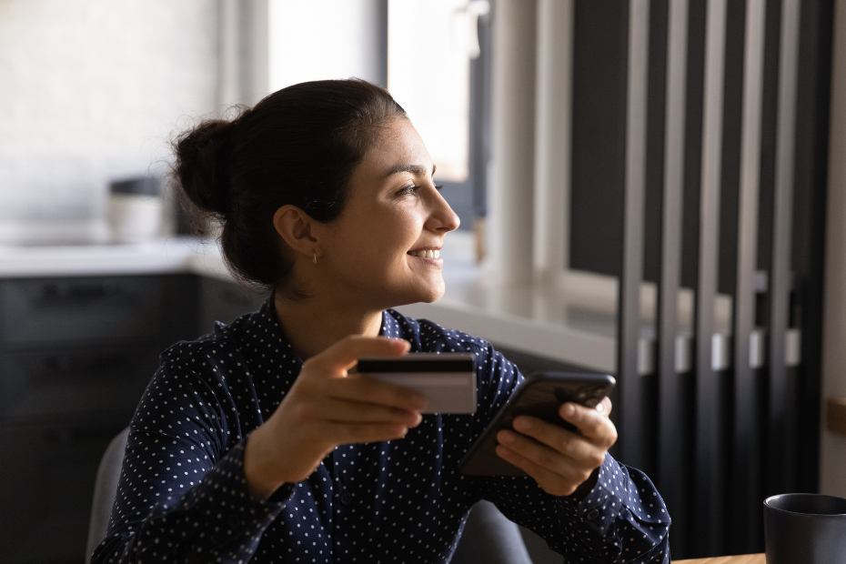 Smiling young Indian female woman shopping online