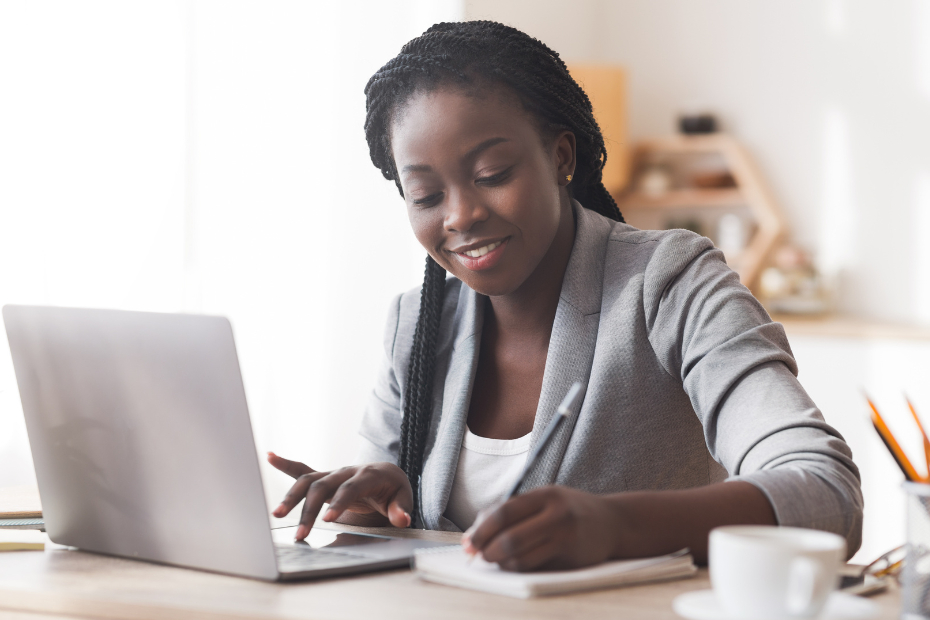 Black female entrepreneur sorting finances on a computer