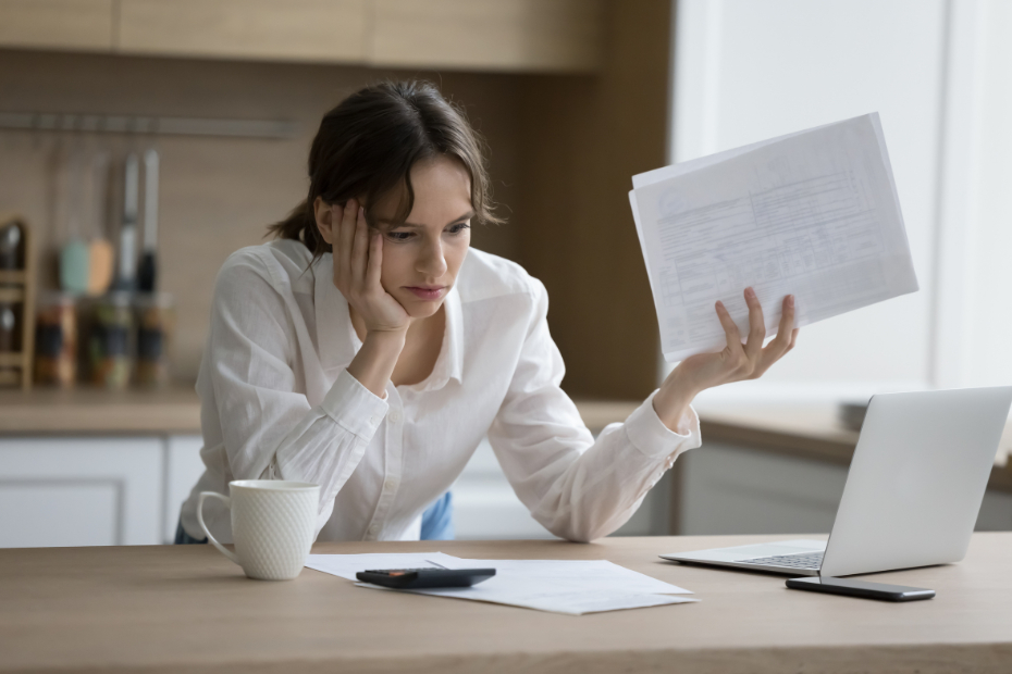Stressed woman looking at her bills