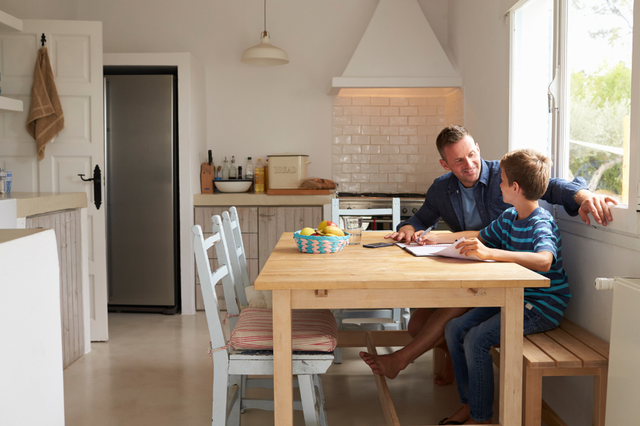 Father and son sitting in their newly renovated kitchen