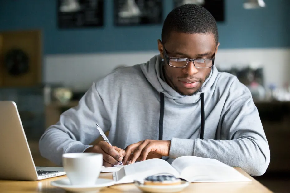 Young African American man studying in the University Library