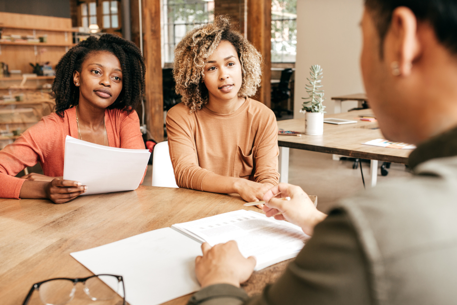 2 female small business owners in a business meeting with an advisor