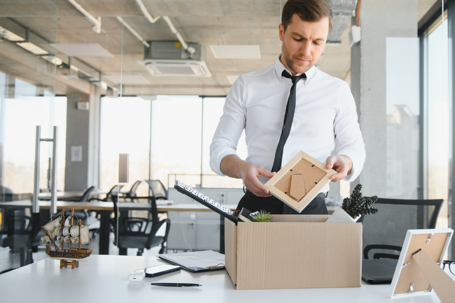 Office Worker Packs His Belongings into Cardboard Box