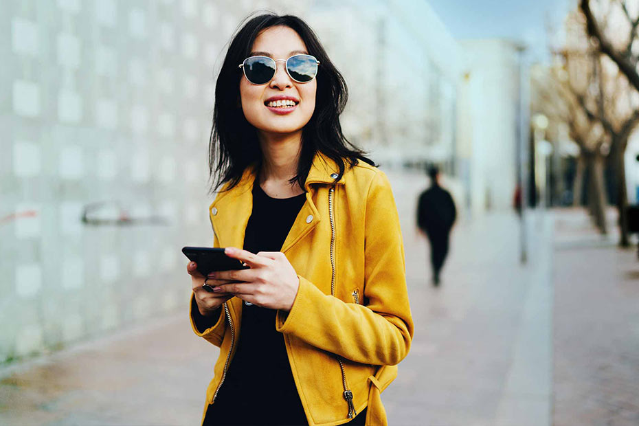 A smiling young Asian woman on the street of Edmonton