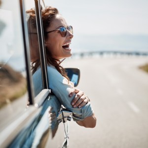 Woman leaning outside of a car.