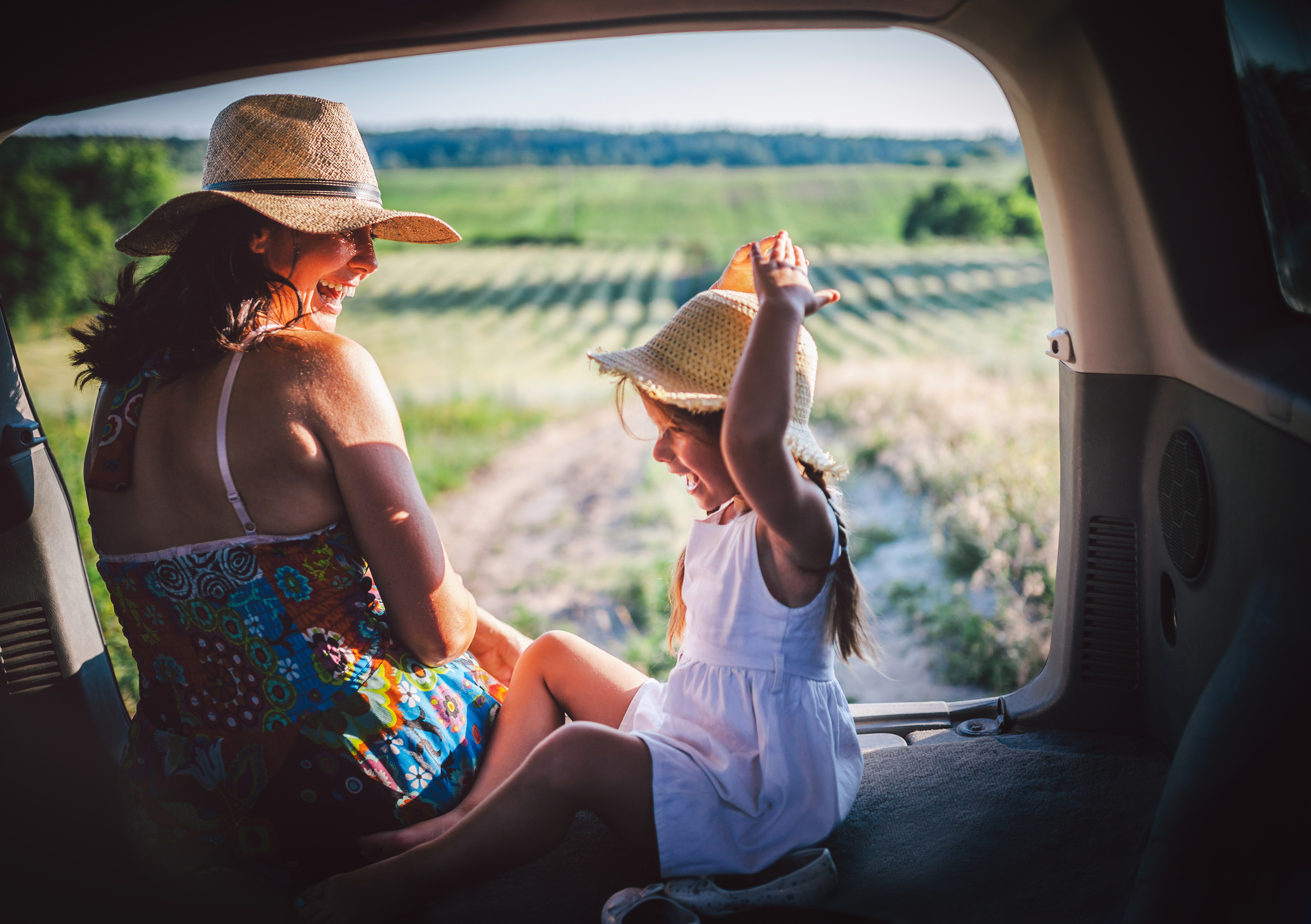 Mother and daughter sitting in a car