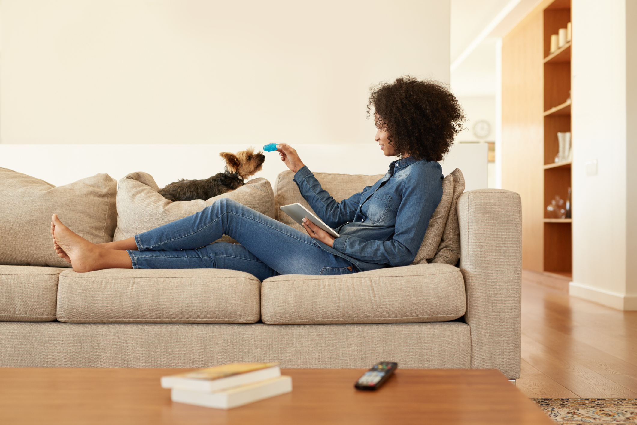 Shot of a young woman relaxing on the sofa with her digital tablet at home