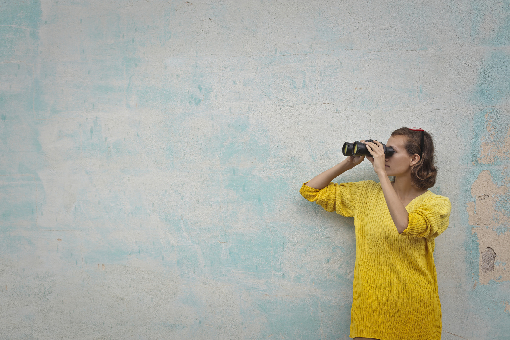 Woman looking through binoculars.