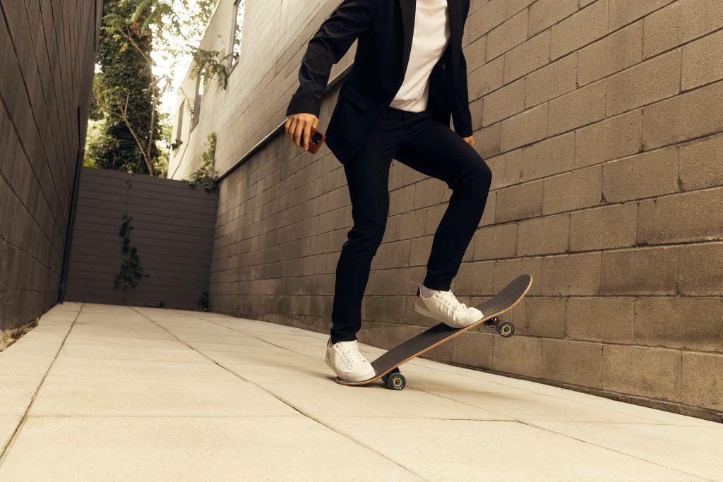 A person leaping on a skateboard.