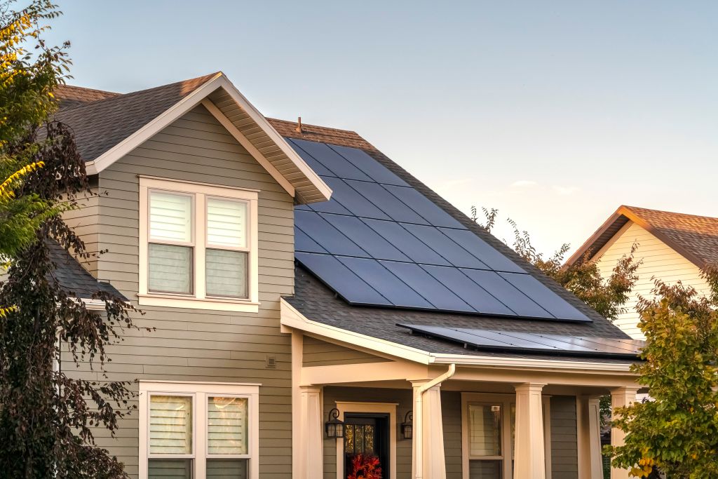 Solar panels on a large, detached home can generate renewable electricity.