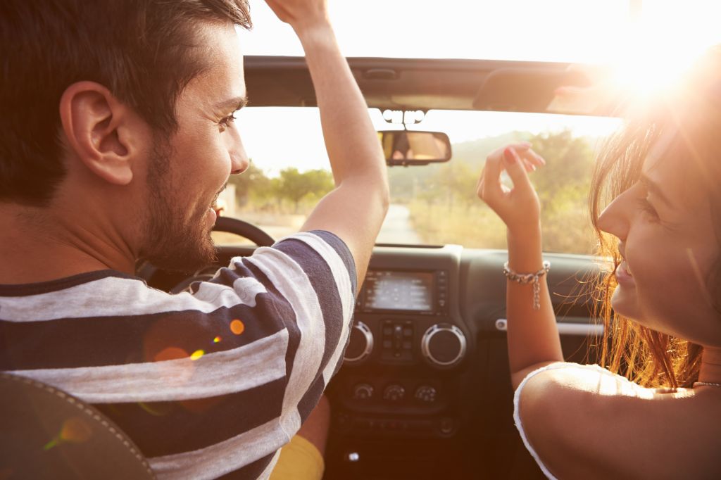 Young couple driving in a car