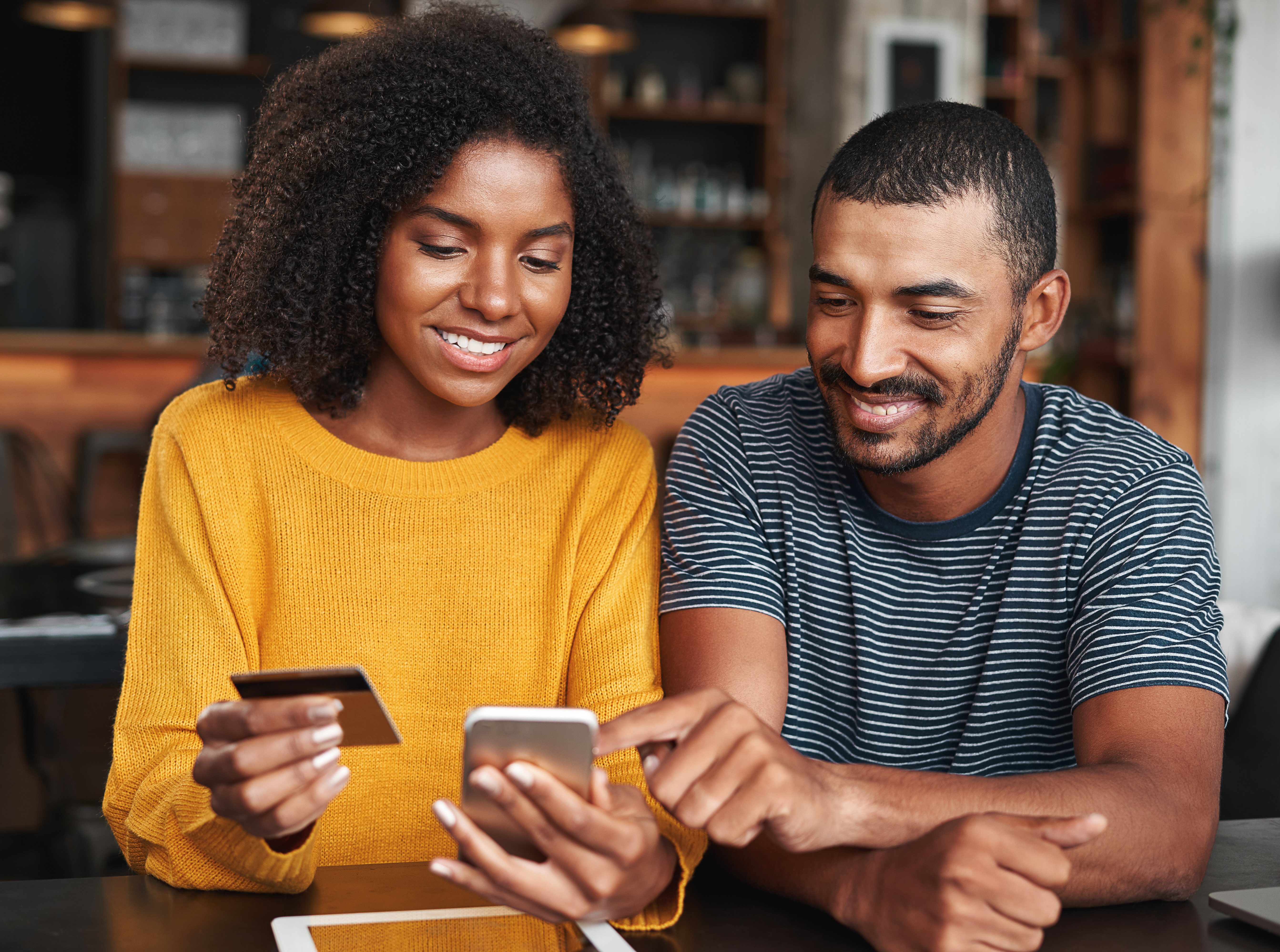 A man and a woman looking at their phone