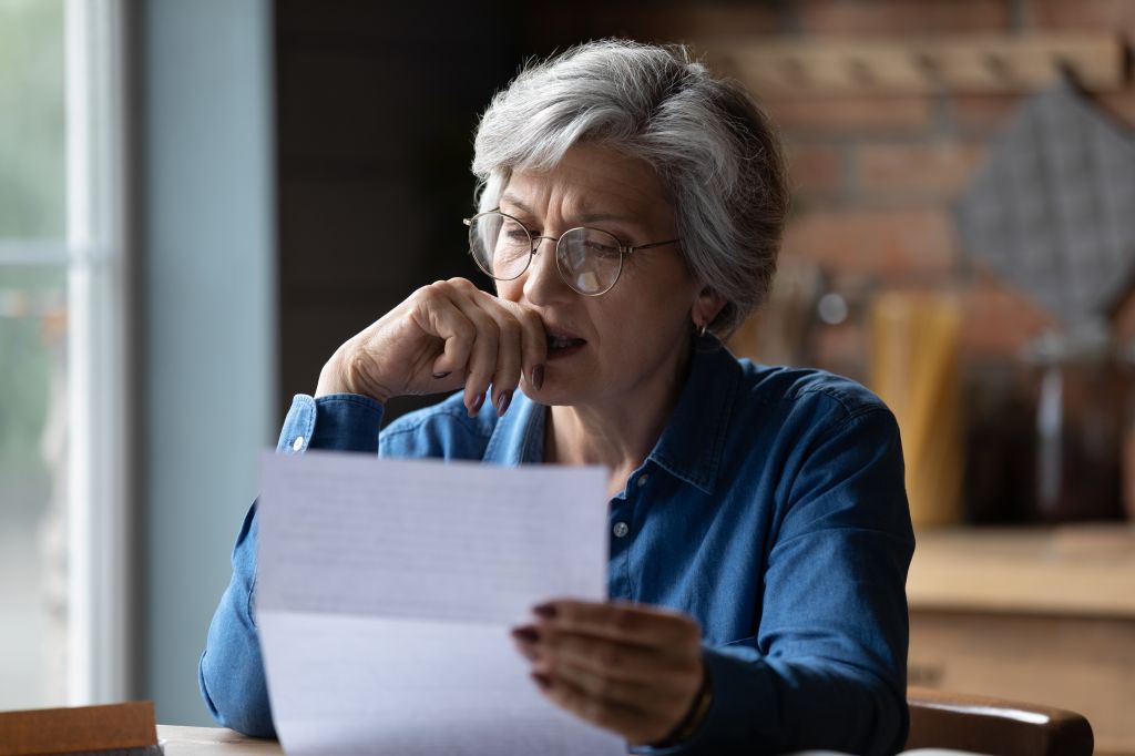 Stressed lady looking at documents