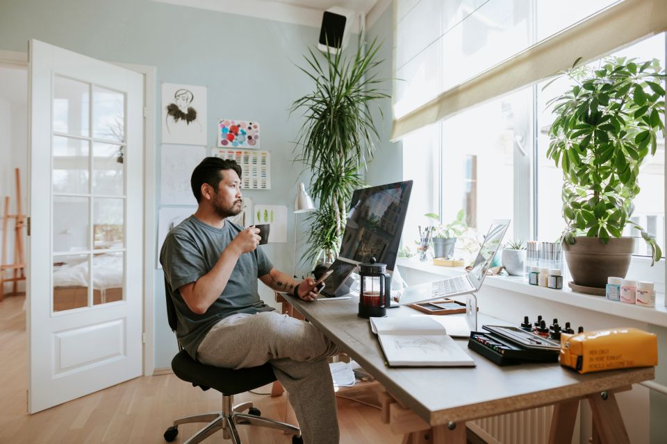 Japanese digital artist at his home studio taking a coffee break.
