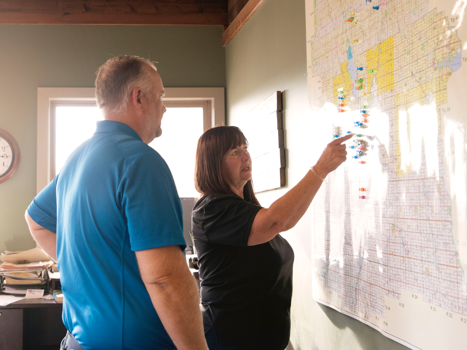 Two people discussing on a blackboard