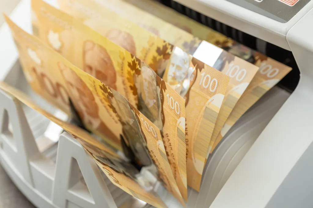 A stack of $100 bills at the teller machine