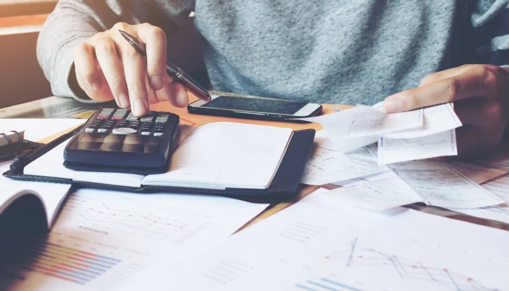 Business owner using calculator at desk