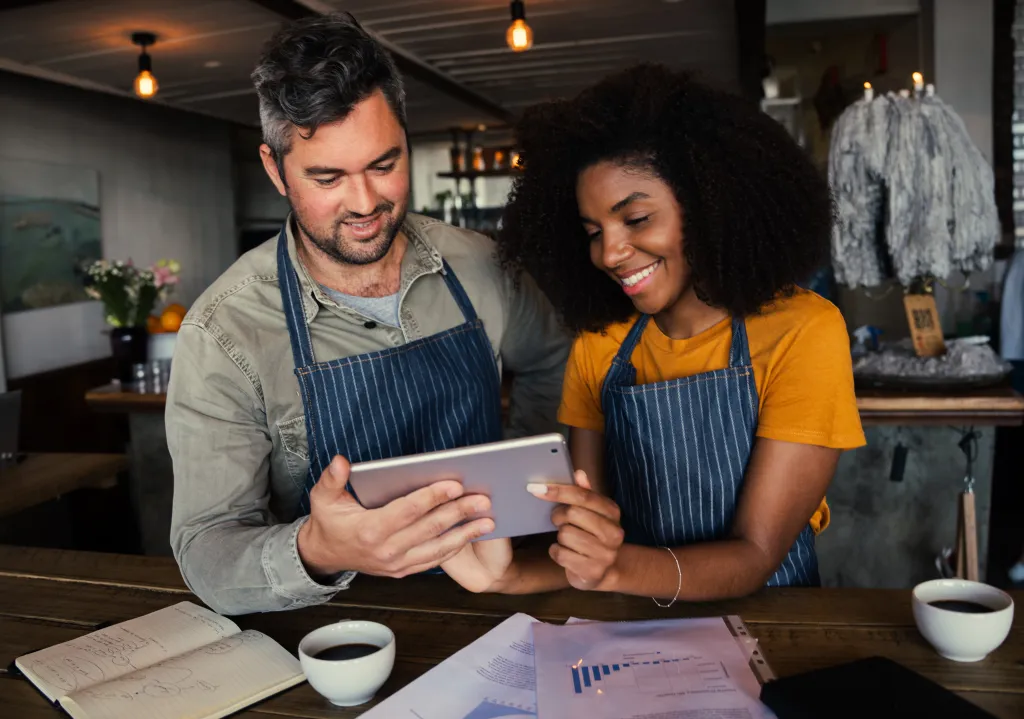 Small business owners looking at financial documents
