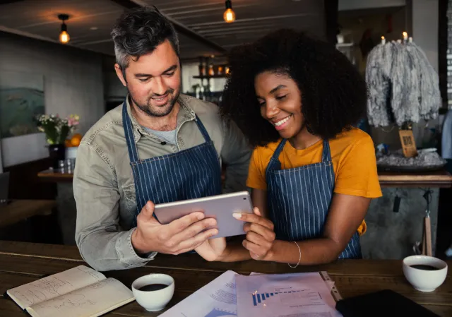 Small business owners looking at financial documents